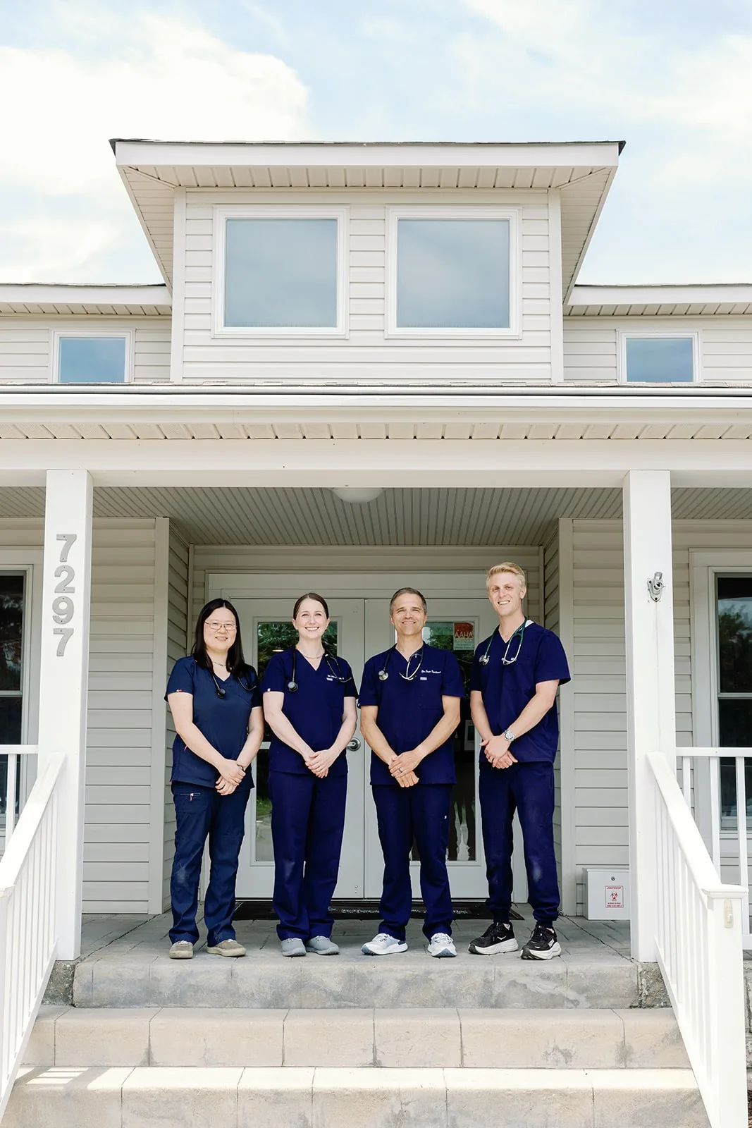 Four Noah's Ark veterinarians outside the hospital entrance in Williamsburg