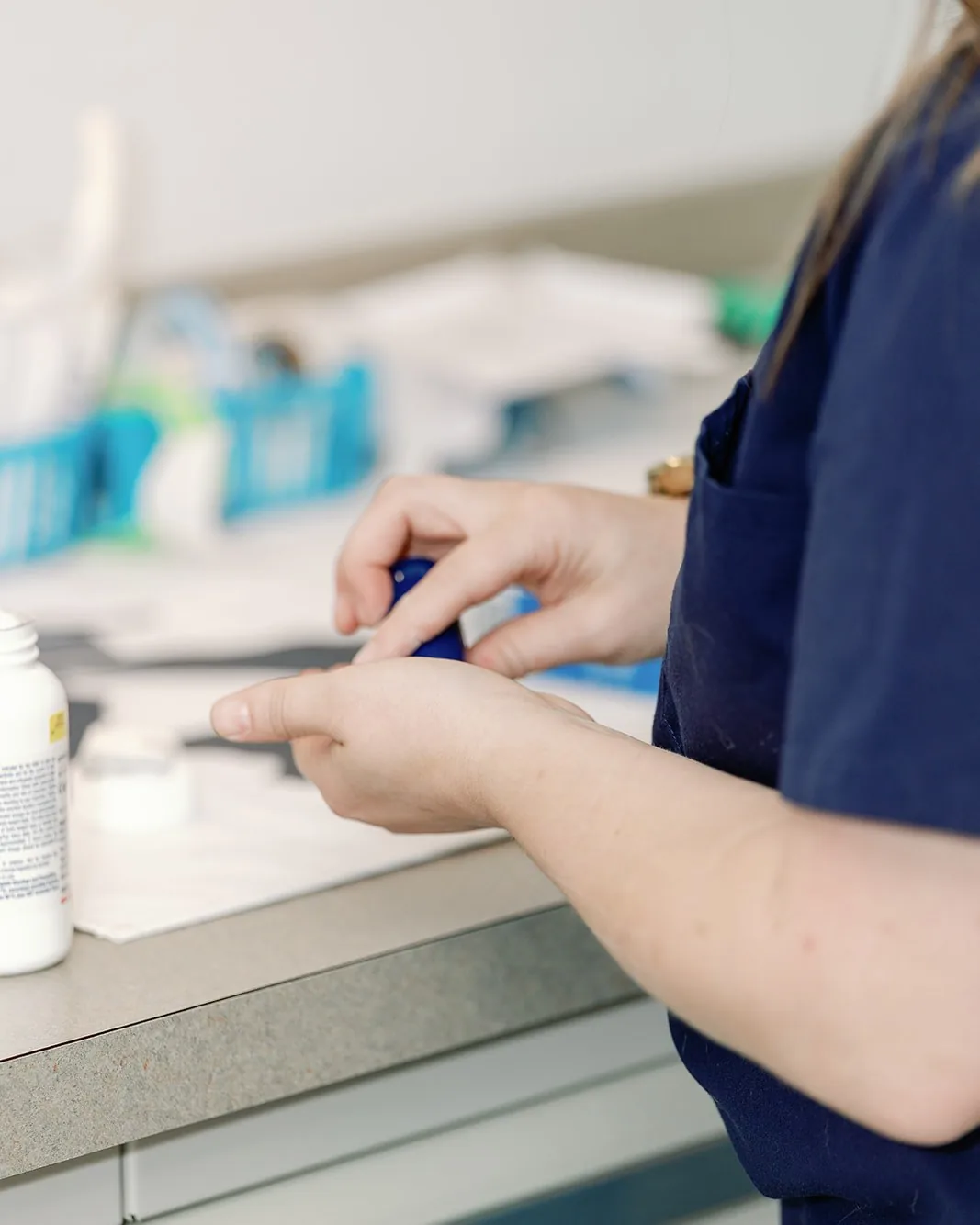 A technician preparing a stained sample slide at the laboratory bench