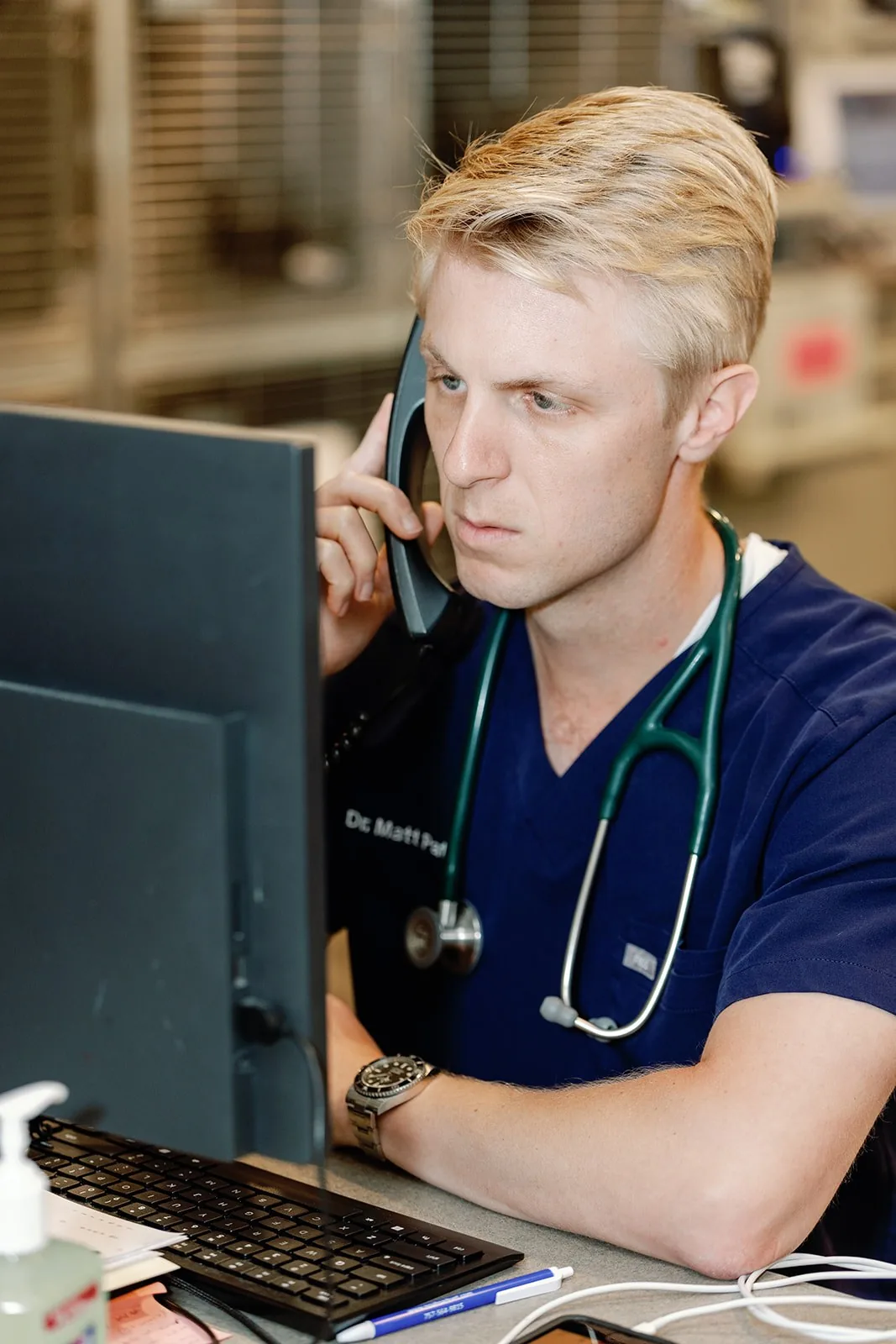 Dr. Mathew Pate taking a call at the treatment-room workstation